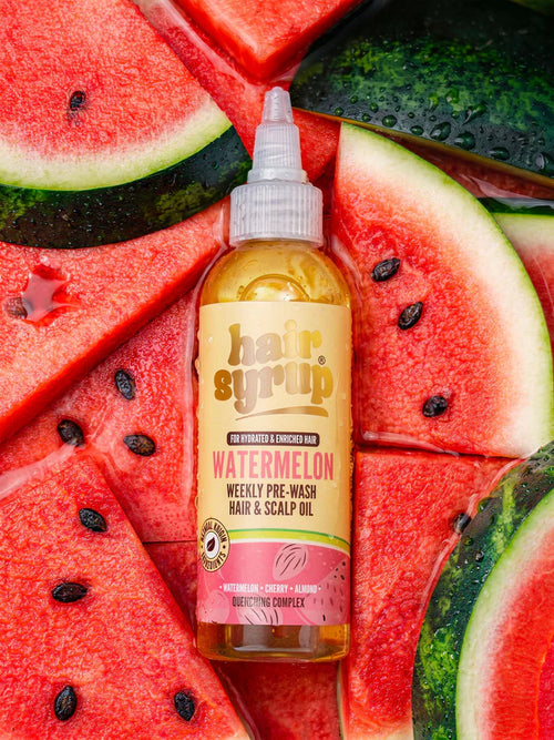 Hair syrup bottle with watermelon flavor on a background of watermelon slices