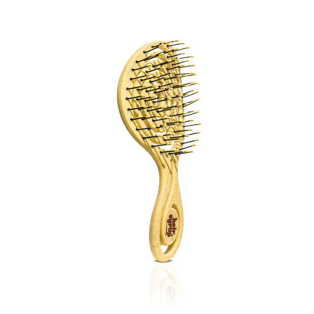 Gold hairbrush on a white background